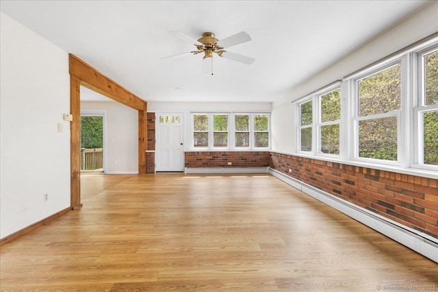 unfurnished sunroom featuring a baseboard radiator