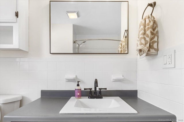 full bathroom featuring vanity, a shower, and tasteful backsplash