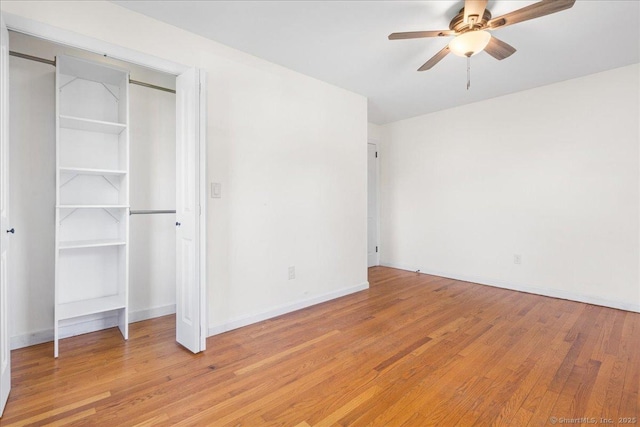 unfurnished bedroom featuring baseboards, ceiling fan, and light wood-type flooring