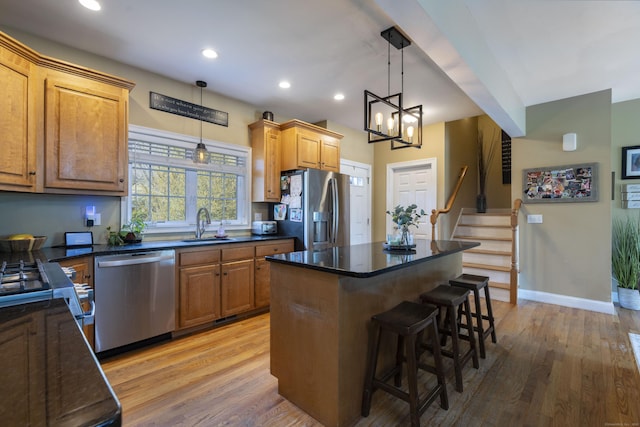 14 Cutter Dr, Stonington, CT 06355 - kitchen with stainless steel appliances, a sink, light wood finished floors, a breakfast bar area, and recessed lighting