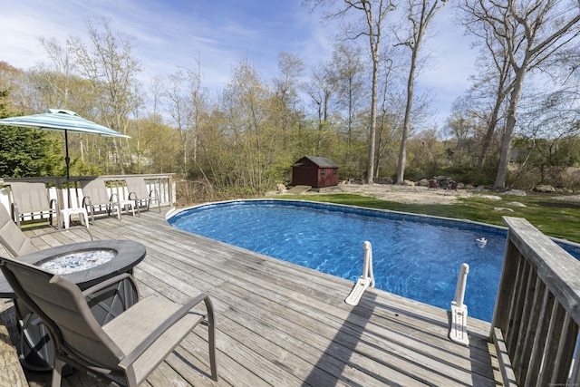 14 Cutter Dr, Stonington, CT 06355 - swimming pool with a fire pit, a deck, a shed, and an outdoor structure