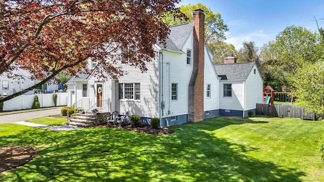 view of front of home featuring a shingled roof and a chimney
