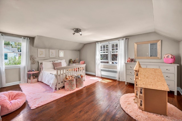 bedroom with radiator, lofted ceiling, dark wood-style floors, and baseboards