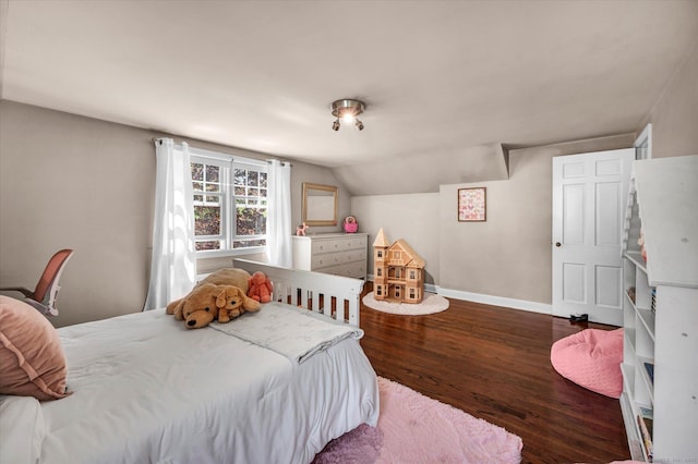 bedroom with wood finished floors, baseboards, and lofted ceiling