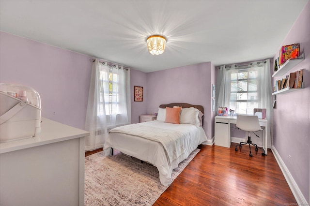 bedroom with wood finished floors, a desk, and baseboards