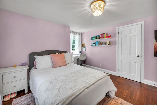 bedroom featuring wood finished floors and baseboards