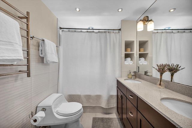 bathroom featuring tile walls, double vanity, toilet, tile patterned flooring, and shower / tub combo