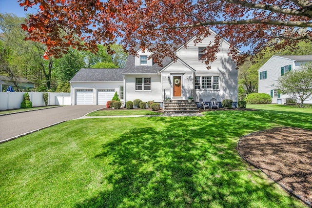 traditional home with driveway, an attached garage, and roof with shingles