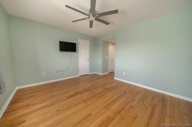 unfurnished room with light wood-style floors, baseboards, and ceiling fan
