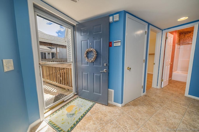 entrance foyer with baseboards, tile patterned floors, and visible vents