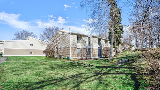 view of side of home featuring a lawn