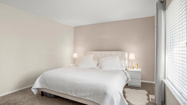 carpeted bedroom featuring baseboards