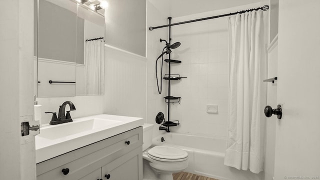 bathroom with vanity, shower / bath combo with shower curtain, and toilet