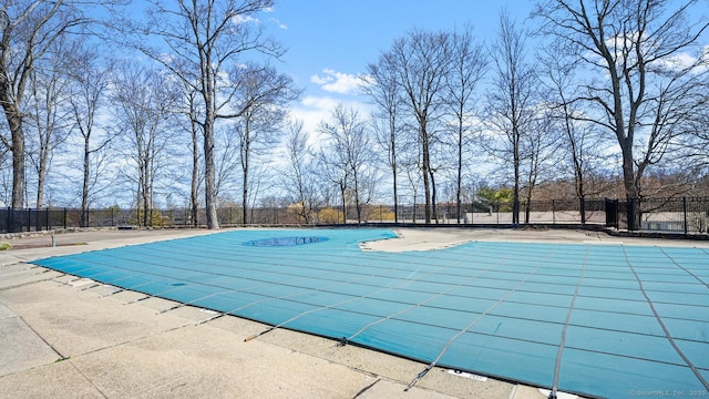 view of swimming pool featuring fence