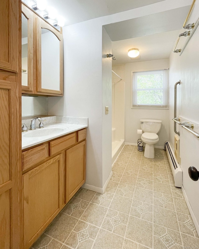 full bath featuring vanity, toilet, baseboards, a shower, and a baseboard heating unit