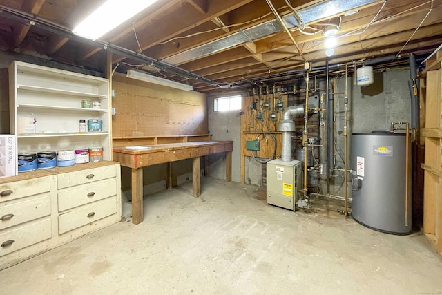 below grade area with a heating unit, a workshop area, and gas water heater