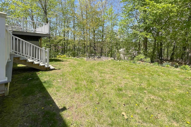 view of yard featuring stairs and a deck