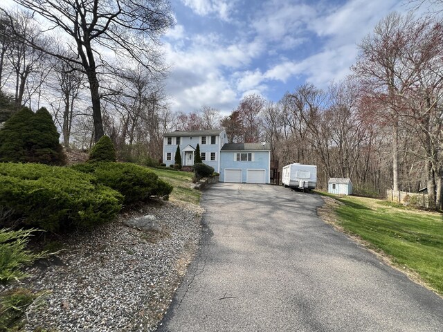 31 Hi Lea Farm Rd, Colchester, CT 06415 - view of front of house with a garage, a front lawn, and aphalt driveway