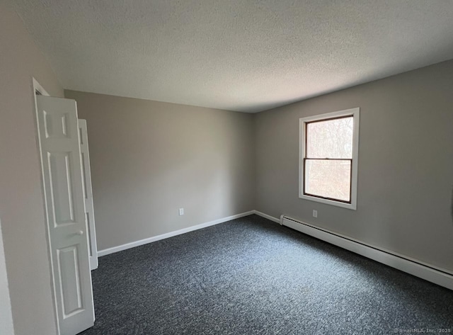 31 Hi Lea Farm Rd, Colchester, CT 06415 - unfurnished room with baseboards, a textured ceiling, a baseboard heating unit, and dark carpet