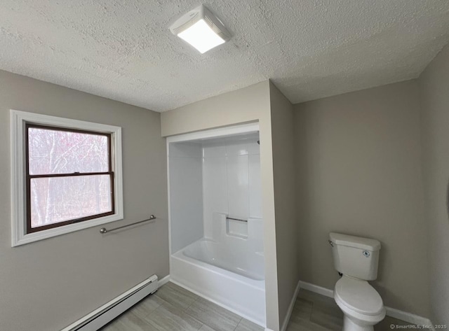 bathroom featuring baseboards, a baseboard radiator, toilet, and a textured ceiling