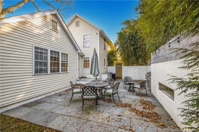 view of patio with outdoor dining area and fence