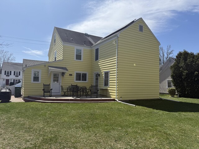 rear view of property with a lawn and a deck