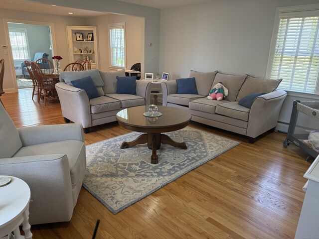 living area with light wood-style floors and recessed lighting