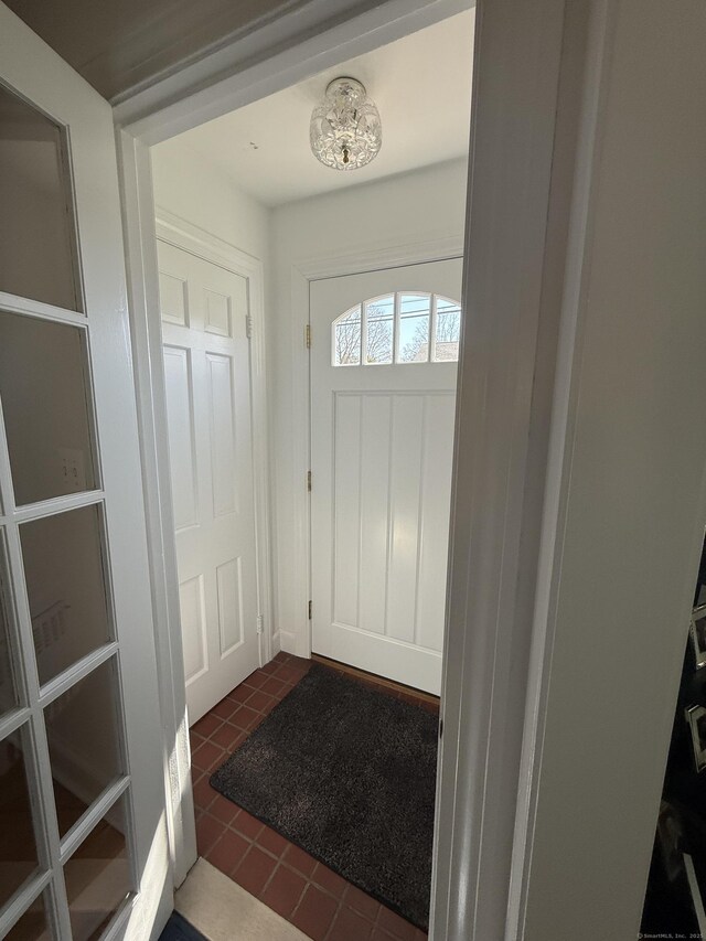 foyer entrance with dark tile patterned flooring