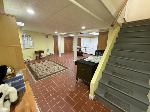 interior space featuring recessed lighting, a baseboard heating unit, and stairway