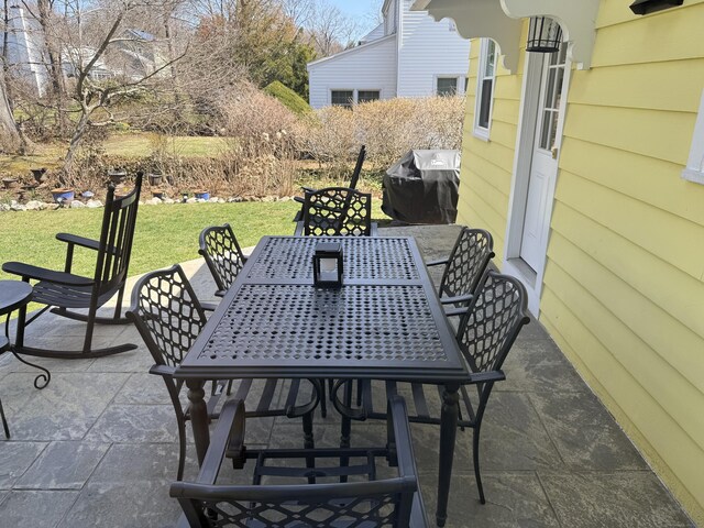 view of patio with outdoor dining area and a grill
