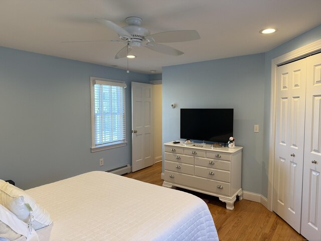 bedroom featuring light wood-style floors, recessed lighting, baseboards, a baseboard radiator, and a closet