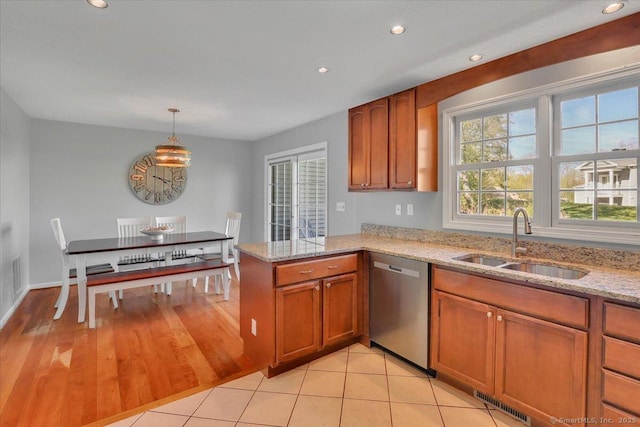 kitchen featuring brown cabinetry, a sink, dishwasher, and recessed lighting