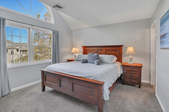 bedroom with visible vents, baseboards, vaulted ceiling, and light carpet