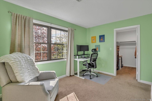 carpeted office space featuring baseboards