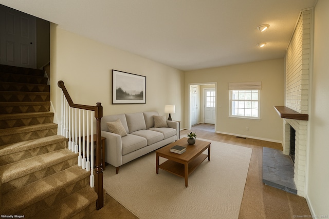 267 Strawberry Cir, Windsor, CT 06095 - living area featuring stairway, carpet, a fireplace, and baseboards