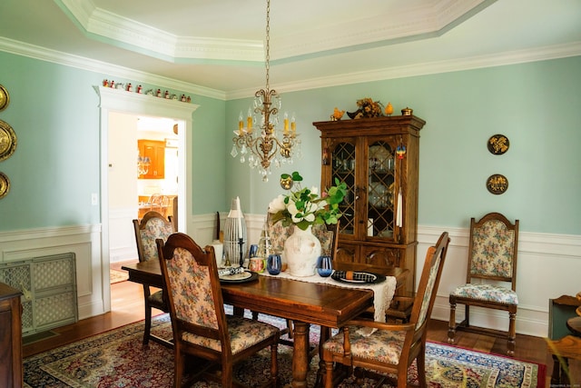 45 N Gate Rd, Woodbury, CT 06798 - dining space with a chandelier, wood finished floors, wainscoting, ornamental molding, and a raised ceiling