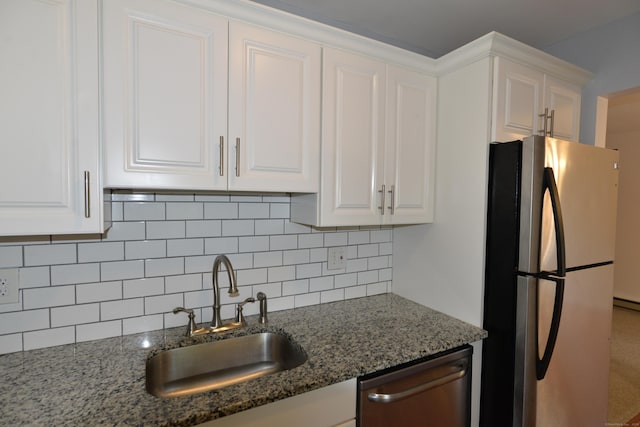 kitchen featuring appliances with stainless steel finishes, a sink, and white cabinets