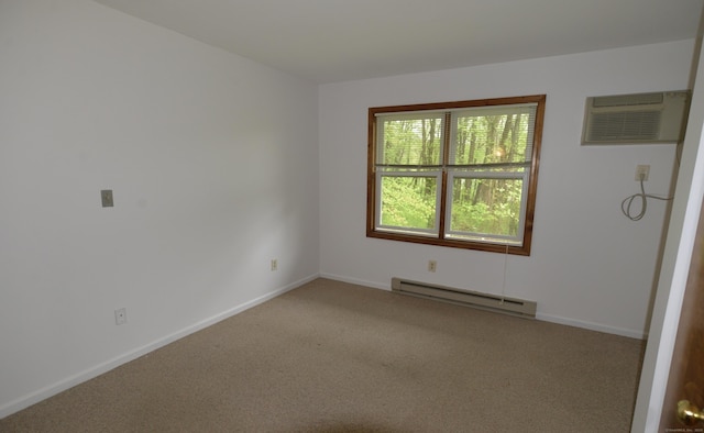 unfurnished room with a baseboard heating unit, carpet flooring, a wall mounted air conditioner, and baseboards
