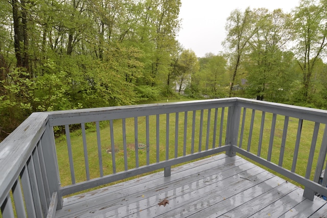 wooden terrace featuring a yard