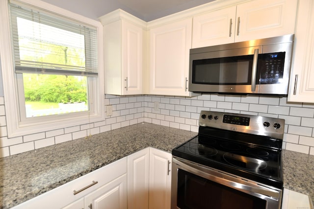 107 Hidden Knolls Cir Unit 107, Monroe, CT 06468 - kitchen with stainless steel appliances, backsplash, white cabinetry, and stone counters