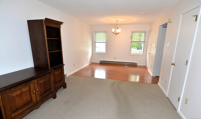 107 Hidden Knolls Cir Unit 107, Monroe, CT 06468 - unfurnished living room with a baseboard radiator, carpet, a chandelier, wood finished floors, and baseboards