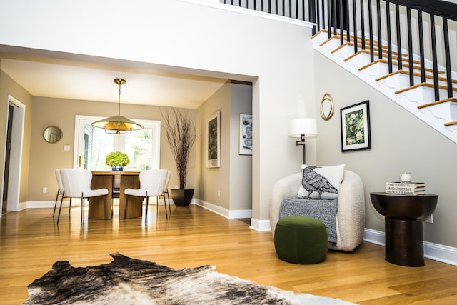 interior space featuring baseboards, stairs, and wood finished floors