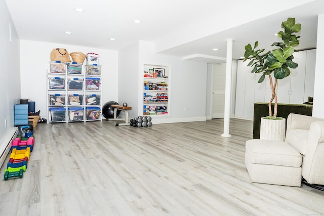 rec room featuring baseboard heating, recessed lighting, baseboards, and wood finished floors