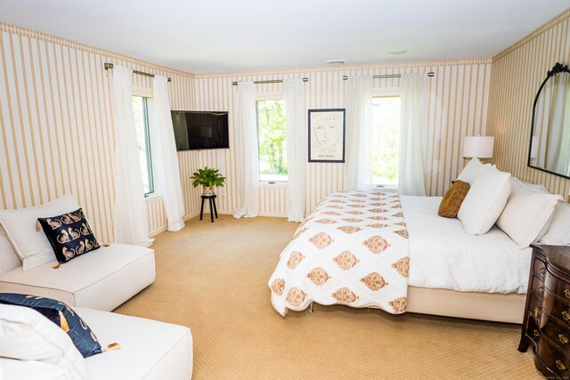 bedroom featuring carpet floors, wallpapered walls, and visible vents