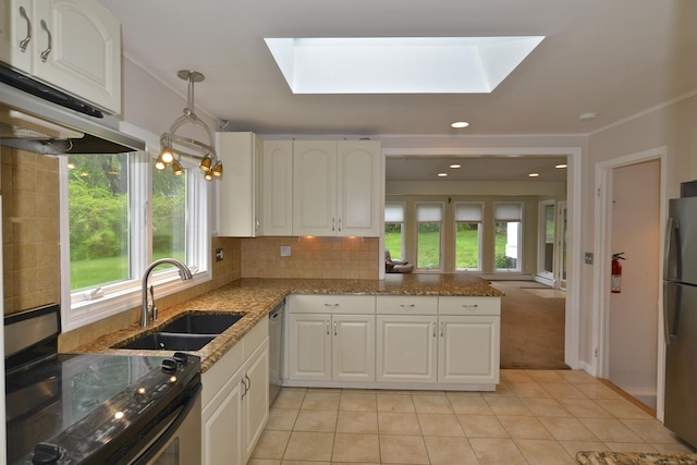 59 Old Ridgebury Rd, Danbury, CT 06810 - kitchen featuring a sink, a skylight, light tile patterned floors, and appliances with stainless steel finishes