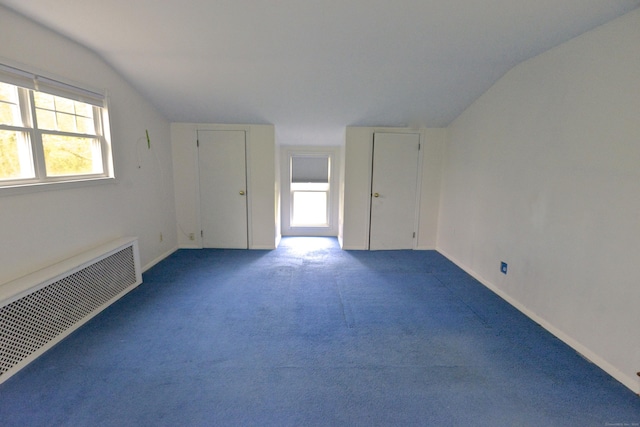 59 Old Ridgebury Rd, Danbury, CT 06810 - carpeted spare room with lofted ceiling, baseboards, radiator heating unit, and visible vents