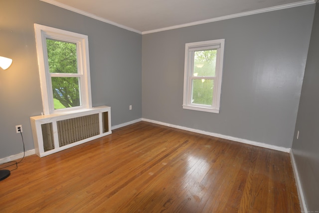 59 Old Ridgebury Rd, Danbury, CT 06810 - spare room with baseboards, radiator, ornamental molding, and wood finished floors