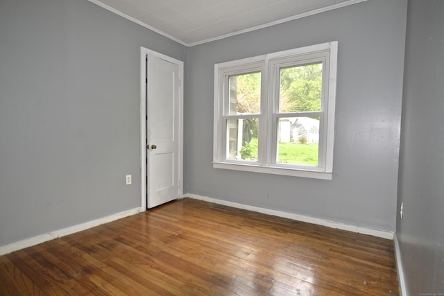 59 Old Ridgebury Rd, Danbury, CT 06810 - unfurnished room with baseboards, hardwood / wood-style floors, a healthy amount of sunlight, and crown molding