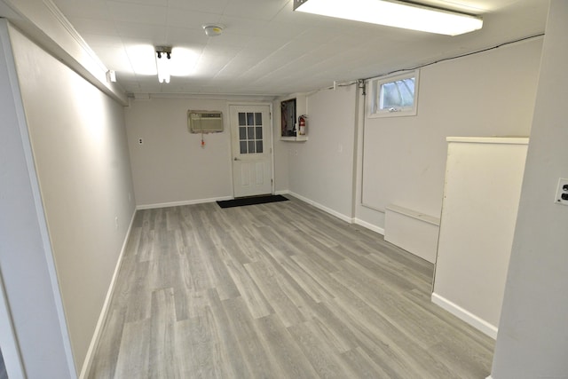 59 Old Ridgebury Rd, Danbury, CT 06810 - below grade area featuring baseboards, light wood-style flooring, and a wall unit AC