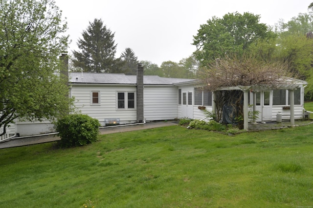 59 Old Ridgebury Rd, Danbury, CT 06810 - back of house with a yard, a patio, and a chimney